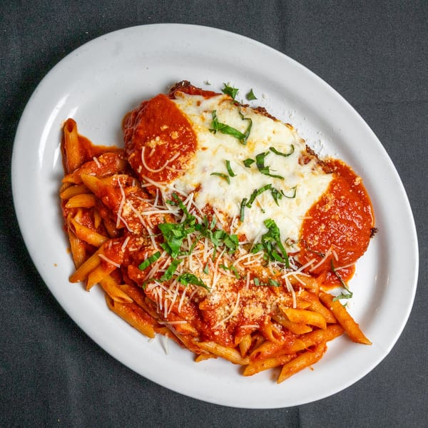 Chicken parmesan with penne pasta, marinara sauce, melted mozzarella, and fresh basil.